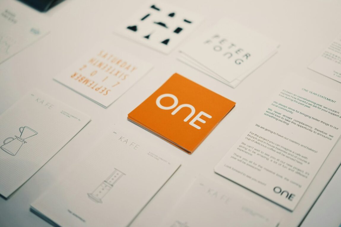 Brand identity materials including business cards and stationery on a desk