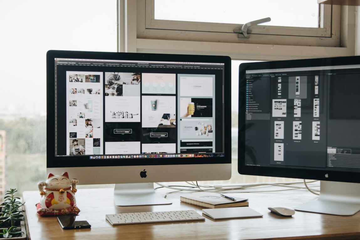 Dual monitor setup displaying a modern website design layout