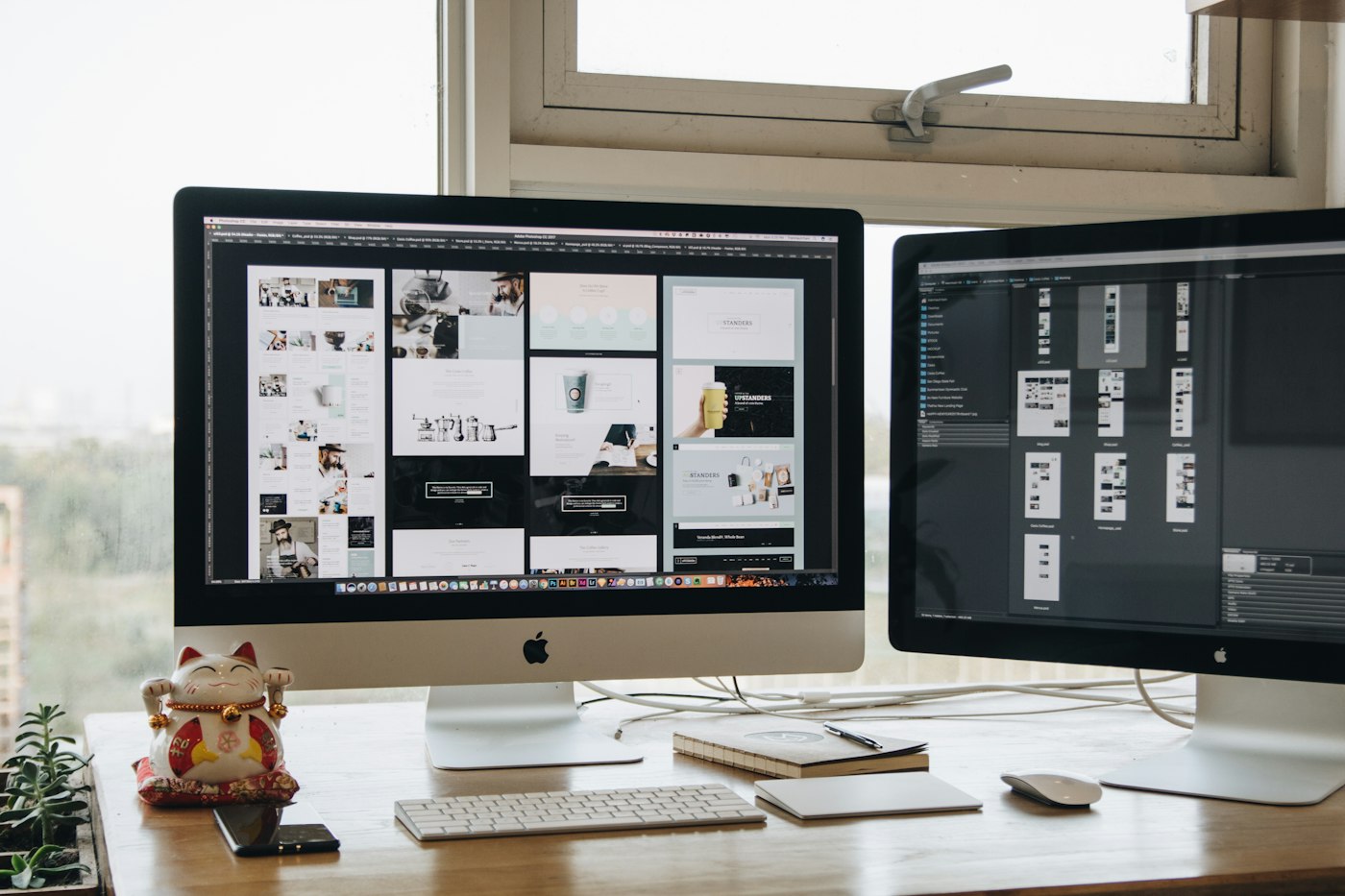 Dual monitor setup displaying a modern website design layout